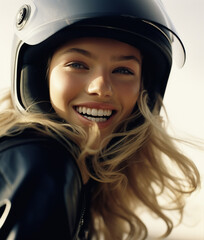 Portrait of smiling beautiful woman biker wearing a helmet