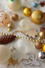 Various colorful Christmas oranments and white faux fur blanket. Selective focus.