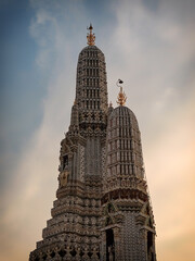 This majestic temple in Bangkok, Wat Arun, is a towering and ornate structure in Thailand with...