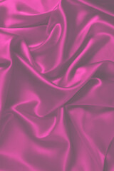 Red silk or satin luxury fabric texture can use as abstract background. Top view.