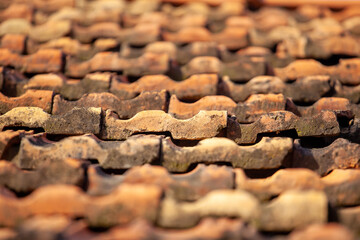 Detail of an old tiled roof on an old house