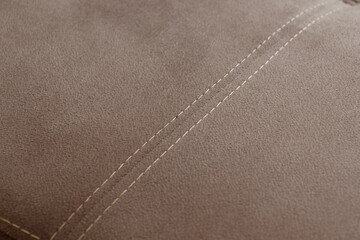 Stitch on beige fabric background