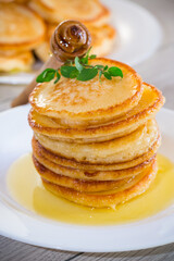 cooked sweet pancakes with honey in a plate