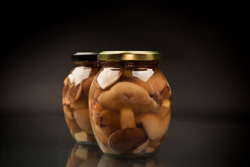 pickled wild boletus mushrooms in a glass jar