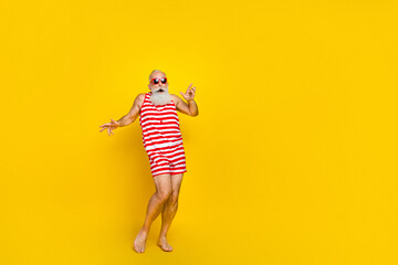 Full length photo of funky impressed senior man wear red striped swimsuit dancing discotheque empty...