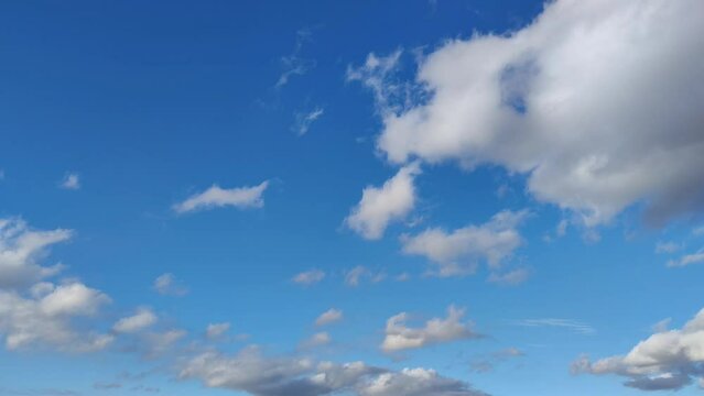 Day with very clear blue sky with few cumulus clouds