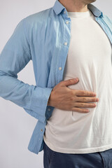 Man suffering from stomach ache on grey background. Health care concept