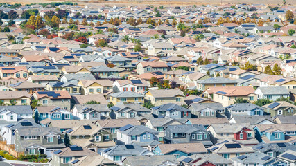 Drone photo of a community in Oakley, California with houses, cars, streets and solar