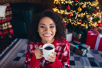 Photo of adorable cheerful girl wear red ornament pullover hold enjoy testy beverage teatime break pause comfort home alone indoors - obrazy, fototapety, plakaty