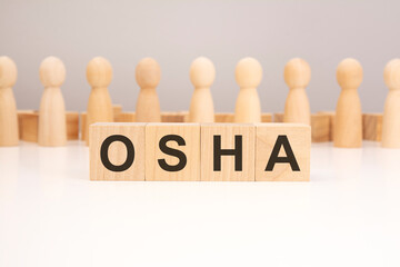 OSHA - word composed from wooden blocks letters on white background, copy space for text
