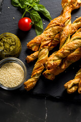 Bread sticks with sesame and tomato with pesto sauce