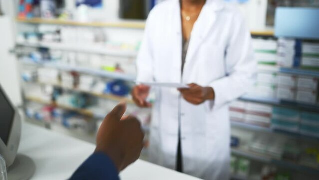 Pharmacy, medicine and customer with prescription for pharmacist at a dispensary with help, advice or treatment. Pharma, retail and hands of people at a counter for drug store purchase, trust or care