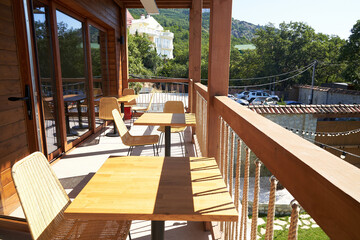 Tables and chairs on the balcony in the restaurant with mountain views. The concept of travel. Scenic view