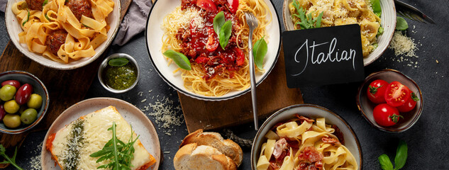 Assortment of Italian pasta with traditional sauces for dinner. Homemade food concept.