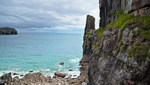 View of Pembrokeshire Coast National Park in Wales. Rochy Cliffs by the seashore near Saint Govan's Chapel, 4K.
