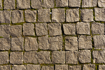 The road is paved with square granite stones.