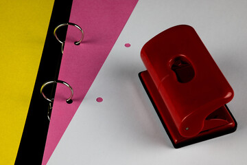 Coloured Card with Hole Punch and White Paper Sheet in an Open Ring Binder - 674834227