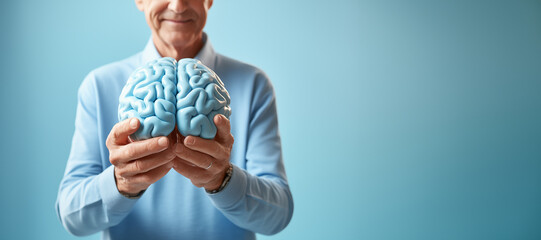 older man holds a model of a brain, concept sanitation, mental health.