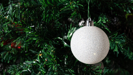 Pine branch and white Christmas balls with space for design. Xmas decoration