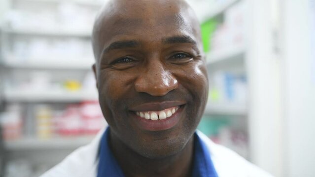 Happy black man, face and pharmacist in healthcare, pharmaceutical or medication stock at drugstore. Portrait of African male person, doctor or medical professional smile in dispensary at pharmacy
