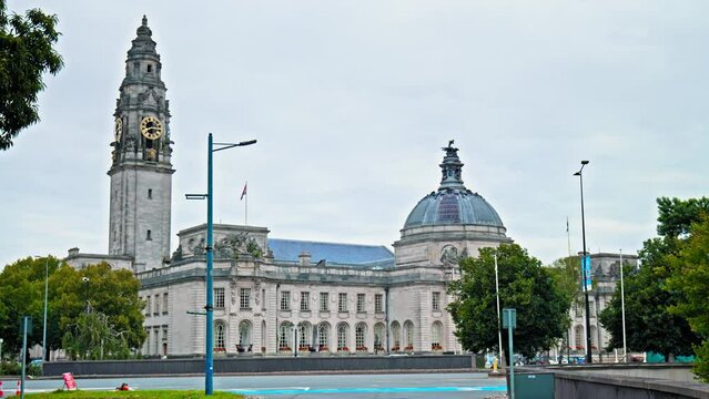 View of Cardiff City Hall municipal building with a clock tower and a Welsh dragon sculpture in Cardiff. The Edwardian baroque civic centre of local government in Wales. 