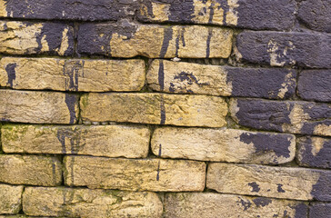 Texture of a brick wall with black paint totec elements.