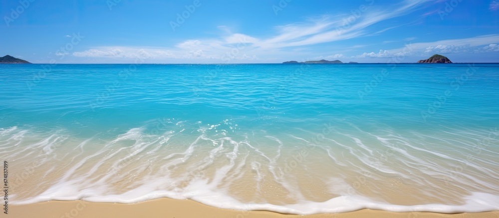 Wall mural the beautiful beach with its blue sea and soft sand is the perfect background for people to connect 