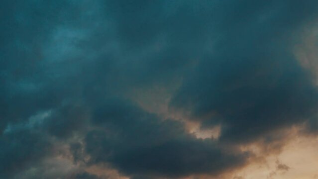 Dark blue clouds transform into a radiant shade of sunny yellow, and then evolve into a captivating red hue. Ever-shifting colors of the sky. Awe-inspiring colors of hope and resilience. Time lapse. - Powered by Adobe