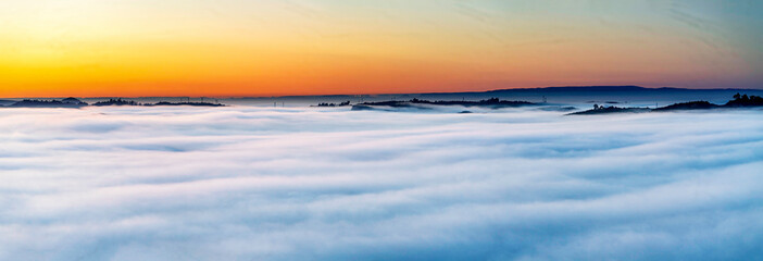 Panorama sunrise, sunset over cloud inversion from view