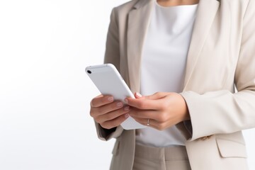 A professional woman in a business suit holding a cell phone. This image can be used to depict a modern working professional or to illustrate concepts related to technology and communication