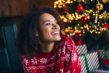 Photo of adorable dreamy lady looking new year decorations enjoying rest relax festal cozy morning magic time house room indoors