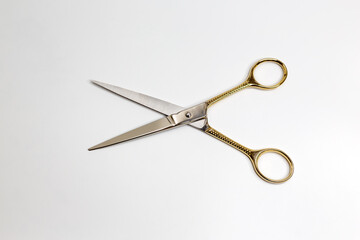 Golden scissors on a white background. Beauty, fashion, haircut, style concept.