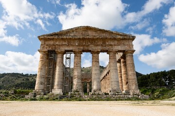 Doric temple of Segesta in sunny spring day with cloudy sky during reconstruction