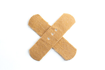 Band-Aids on a white background. Multiplication sign or prohibition sign made with band-aids.