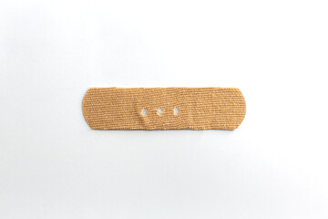 Band-aid on white background. Punctuation mark made with a band-aid dash, hyphen.