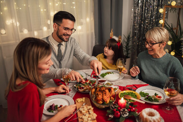 Happy multi-generation family enjoying in a lunch together at home. Family on Christmas dinner at home