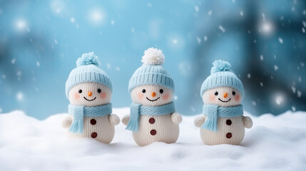 Little knitted snowmans on soft snow