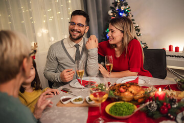 Happy multi-generation family enjoying in a lunch together at home. Family on Christmas dinner at home