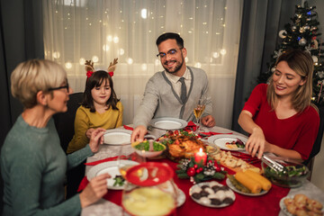 Happy multi-generation family enjoying in a lunch together at home. Family on Christmas dinner at home
