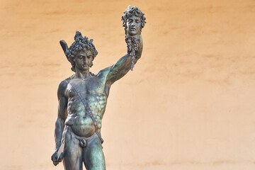Fototapeta na wymiar Bronze statue of Perseus with the head of Medusa, masterpiece by Benvenuto Cellini in Florence, empty space on the right
