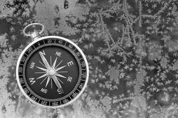 black and white photo of round compass