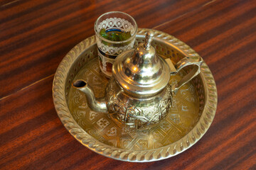 Fototapeta na wymiar Moroccan Mint Tea in Teapot and Glass