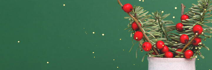 Banner with bouquet of nobilis fir and winterberry branches in front of green background. - obrazy, fototapety, plakaty