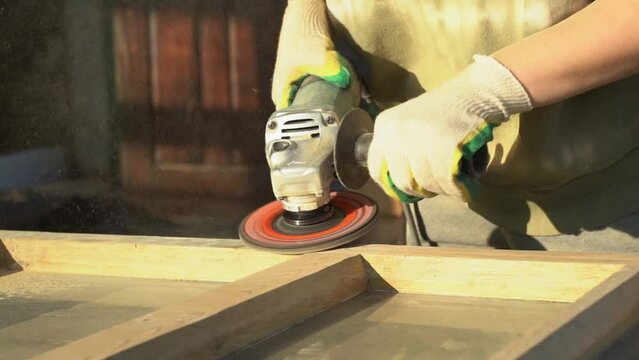 Sanding wood in the workshop. Carpenter working with wood. Restoration, production, private business, concept.