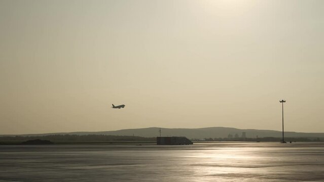 Aircraft is taking off. Side view from terminal. ontour light