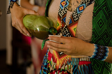 Sao Paulo, SP, Brazil - September 02 2023: Ceremony with Ayahuasca. Person pouring ayahuasca into glass details.