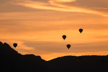 Hot Airl Balloons at Sunrise over Albuquerque and Sandia Mountains, New Mexico