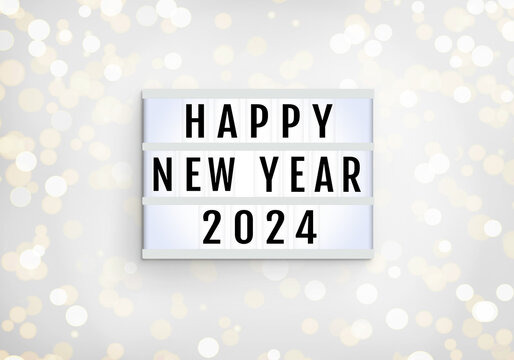 Happy New Year lightbox on lights blur bokeh white background. Light box with inscription Happy New Year and 2024. Decorative glitter festive abstract holiday mockup. Flat lay, top view, close up