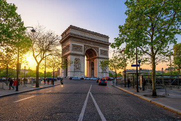 Paris Arc de Triomphe (Triumphal Arch) in Chaps Elysees at sunset, Paris, France. Cityscape of Paris. Architecture and landmarks of Paris