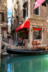 Narrow canal with gondola in Venice, Italy. Architecture and landmark of Venice. Cozy cityscape of...